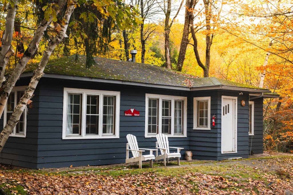 Rushing Water private suite exterior surrounded by vibrant golden autumn foliage at Trillium Resort and Spa Muskoka Port Sydney