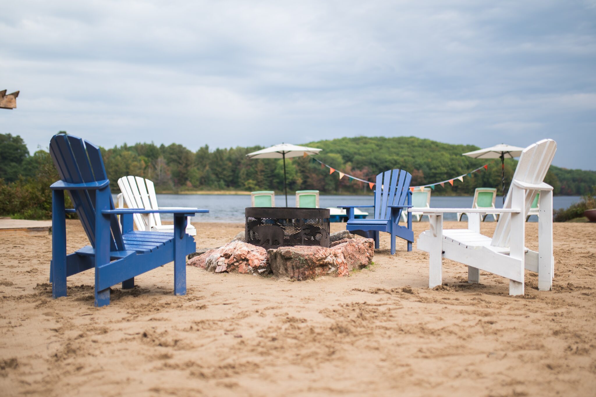 Private sandy beach with Adirondack chairs fire pit and lake views at Trillium Resort and Spa Hotel Muskoka Huntsville Port Sydney