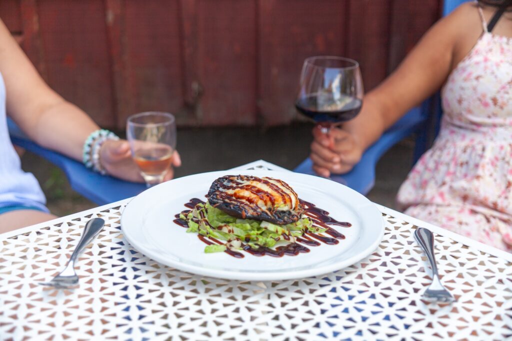 Gourmet portobello mushroom dish paired with wine on outdoor Muskoka patio at Trillium Resort and Spa restaurant Huntsville