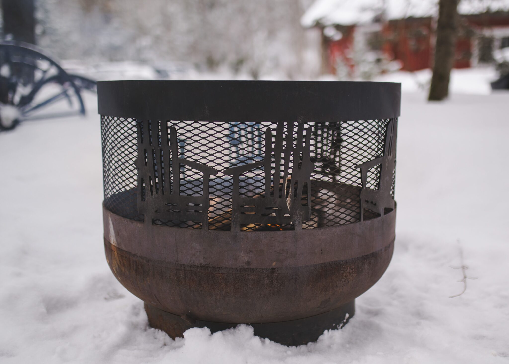 Outdoor firepit glowing on snowy grounds at Trillium Resort and Spa in winter Muskoka Huntsville Port Sydney